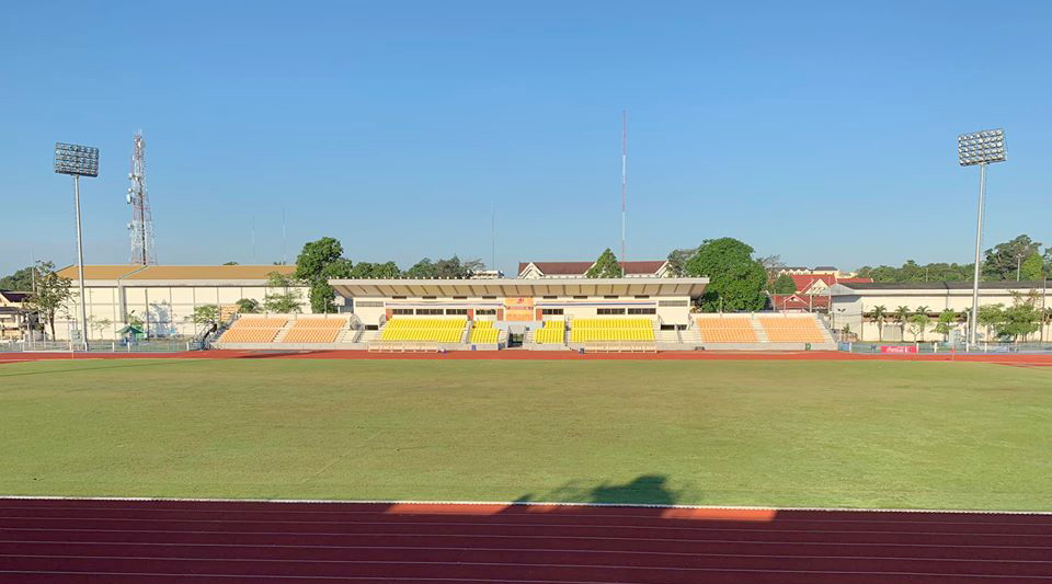 Chanthaburi Province Stadium seen across the running track, with its low main stand under a clear blue sky