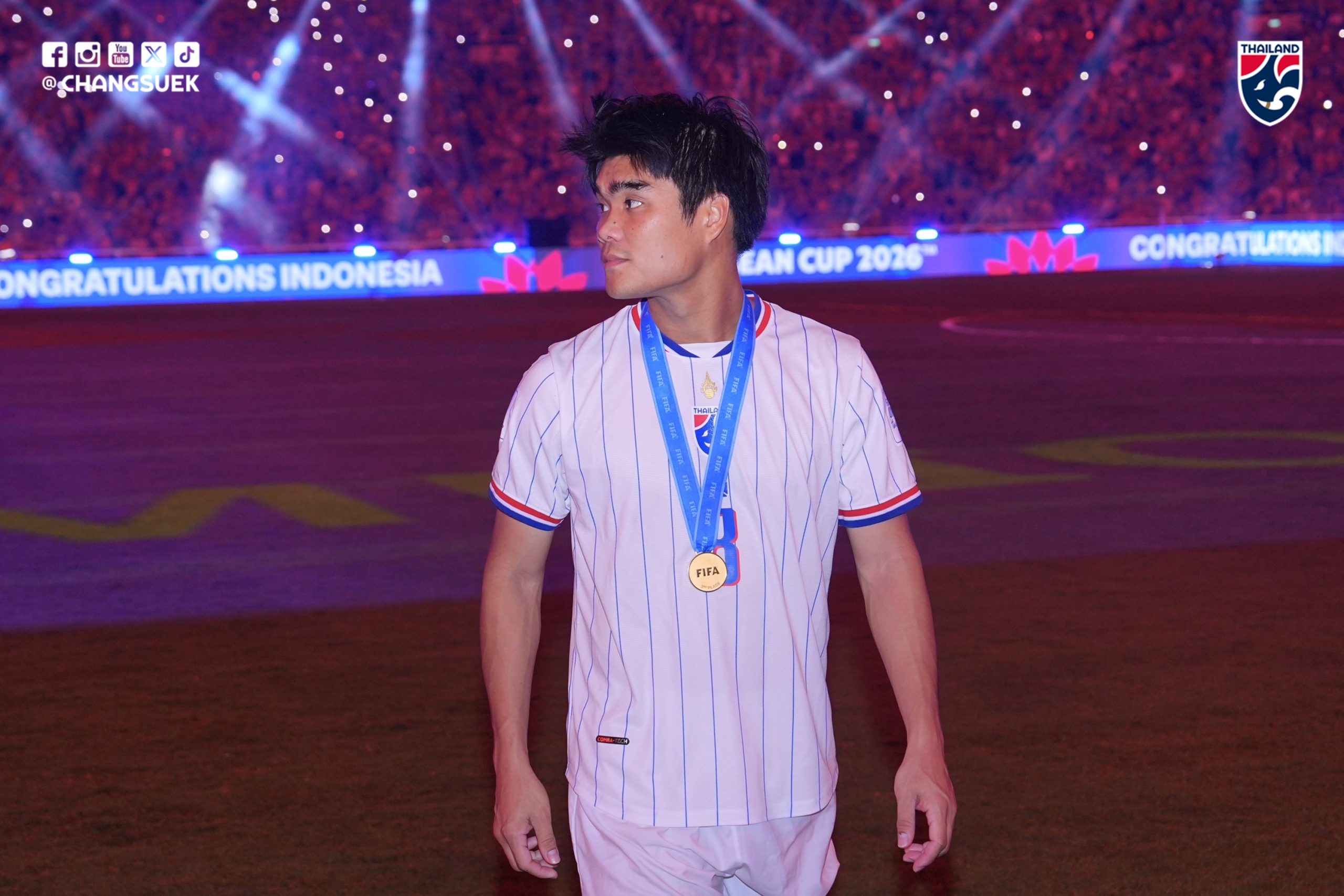 Peeradol Chamratsamee wears his runners-up medal in front of a board reading Congratulations Indonesia