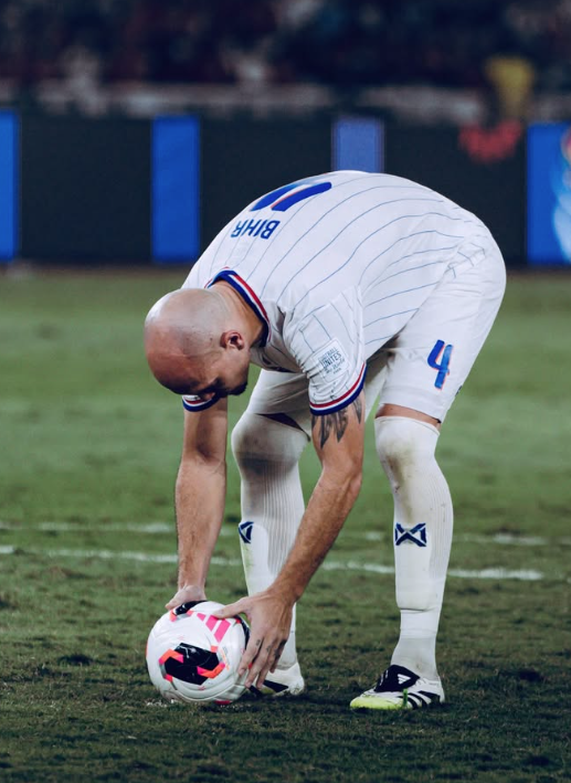 Manuel Bihr bends to place the ball on the spot before his penalty in the ASEAN Cup final shoot-out